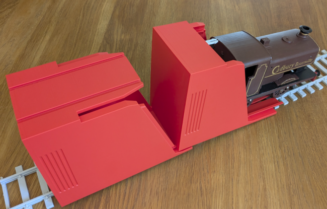 Image of the 3D printed Greenly Locomotive storage box showing locomotive driving out onto the rails